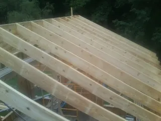 New roof rafters set over an addition before sheathing in Hopewell